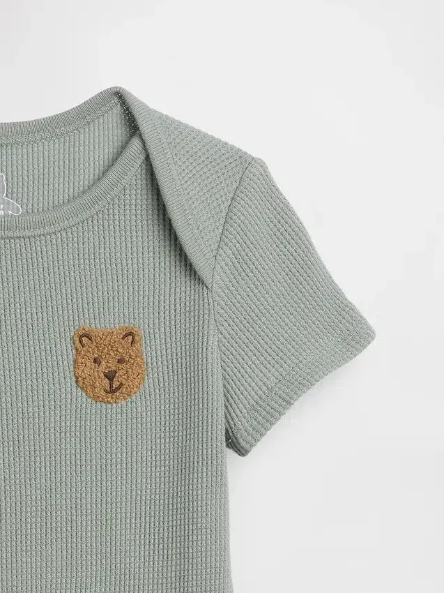 Baby First Favorites bodysuit i våffelstickning