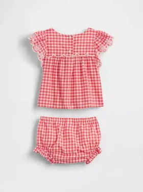 Baby-klädset i gingham med hålbroderi
