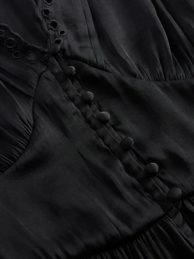 Peplum-top med V-ringning och hålbroderi