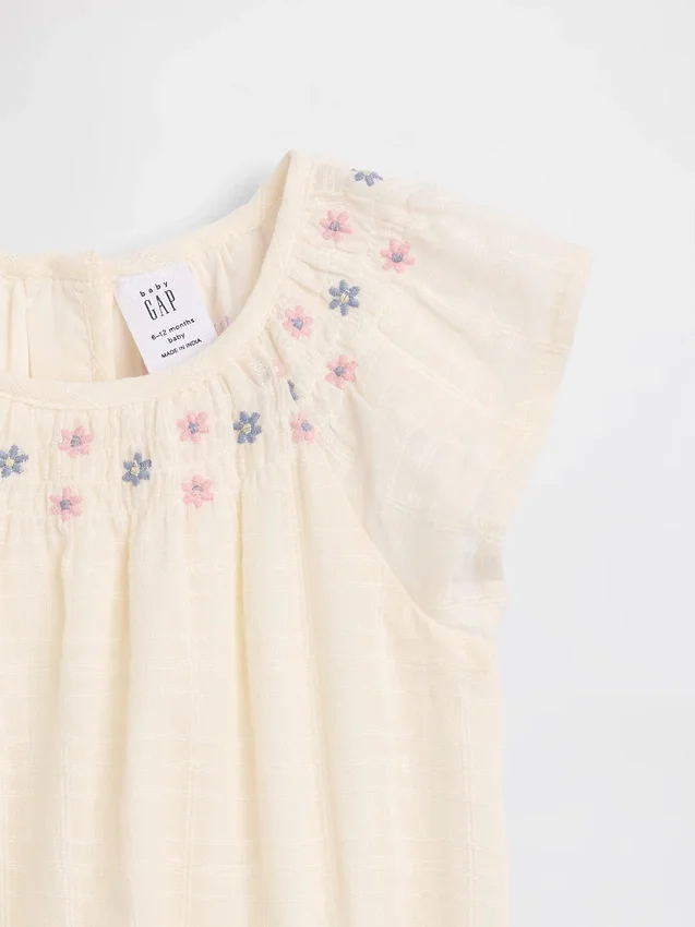 Smockad bodysuit med blommönster för spädbarn