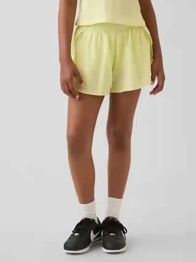 Snabbtorkande löparshorts med fjärilskant för barn