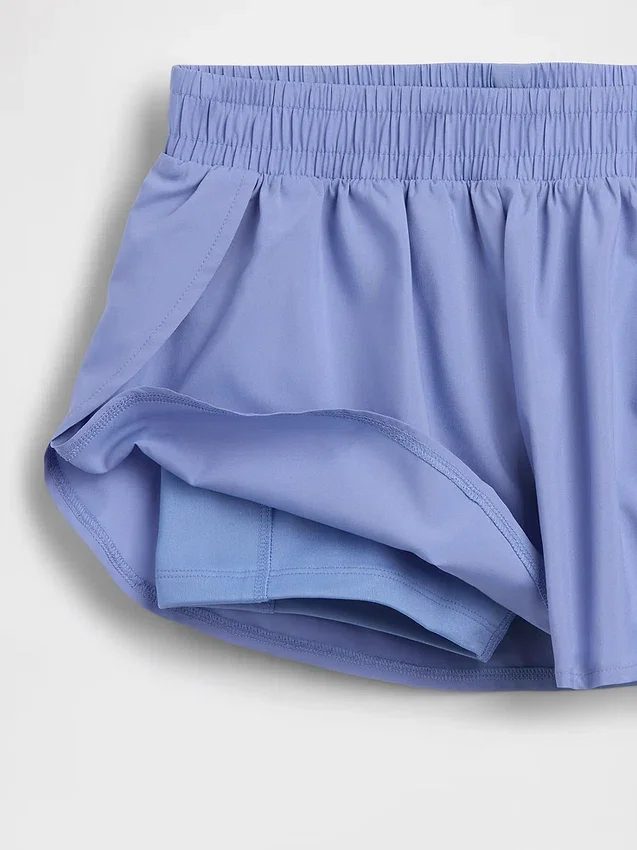 Snabbtorkande löparshorts med fjärilskant för barn